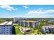 Aerial showcasing condos, a pool, landscaping, and parking overlooking the bay at 1650 1St W Ave # 503B, Bradenton, FL 34205