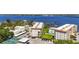 Aerial showcasing two condos, parking, pool, tennis court, and landscaped grounds near a river at 1650 1St W Ave # 503B, Bradenton, FL 34205