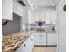 Bright kitchen with white cabinets, granite counters, matching appliances and ample prep space at 1650 1St W Ave # 503B, Bradenton, FL 34205