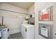 Functional laundry room including a washer, dryer, and built-in shelving for storage convenience at 1650 1St W Ave # 503B, Bradenton, FL 34205