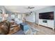 Comfortable living room with ceiling fan, stylish furniture, TV, and ocean themed decor and rug at 1650 1St W Ave # 503B, Bradenton, FL 34205