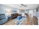Comfortable living room with ceiling fan, stylish furniture and ocean themed decor and rug at 1650 1St W Ave # 503B, Bradenton, FL 34205