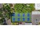 Overhead shot of a community tennis court with lush trees in a residential complex at 1650 1St W Ave # 503B, Bradenton, FL 34205