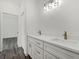 Bathroom with double vanity featuring white cabinets, quartz countertops, and bronze fixtures at Lot 20 Garafola Ave, North Port, FL 34291