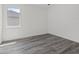 Bedroom with wood-look tile flooring and a large window, featuring a simple, clean design at Lot 20 Garafola Ave, North Port, FL 34291