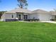 Charming single-story home with well-manicured lawn, stone accents, and a two-car garage at Lot 20 Garafola Ave, North Port, FL 34291