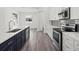Modern kitchen featuring an island with sink, stainless steel appliances, and ample counter space at Lot 20 Garafola Ave, North Port, FL 34291