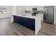 Modern kitchen featuring a large island, stainless steel appliances, and sleek cabinetry at Lot 20 Garafola Ave, North Port, FL 34291