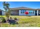 Backyard features manicured lawn, shade trees, and screened lanai at 10519 Spring Tide Way, Parrish, FL 34219