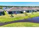 Aerial view of a backyard featuring a screened lanai and tidy landscaping at 10519 Spring Tide Way, Parrish, FL 34219