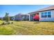 Spacious backyard features manicured lawn, shade trees, and screened-in porches at 10519 Spring Tide Way, Parrish, FL 34219