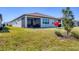 A well-manicured backyard features a screened lanai, lush green lawn, and beautiful landscaping at 10519 Spring Tide Way, Parrish, FL 34219