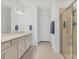 Bright bathroom features double vanity, quartz counters, and glass shower enclosure at 10519 Spring Tide Way, Parrish, FL 34219
