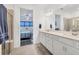 Bright bathroom features double vanity, quartz counters, and a bedroom view at 10519 Spring Tide Way, Parrish, FL 34219