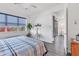 Comfortable bedroom with wood-look flooring, ceiling fan, and a large window with a view at 10519 Spring Tide Way, Parrish, FL 34219