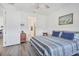 Cozy bedroom features a comfortable bed, wood-look floors, and plenty of natural light at 10519 Spring Tide Way, Parrish, FL 34219
