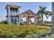 Beautiful entrance to this property features a covered entryway, lush landscaping, and a water feature at 10519 Spring Tide Way, Parrish, FL 34219