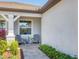Inviting front porch with cozy seating and tasteful landscaping at 10519 Spring Tide Way, Parrish, FL 34219
