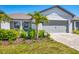 Charming single-story home featuring a well-manicured front yard and a two-car garage at 10519 Spring Tide Way, Parrish, FL 34219