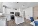 Bright, open kitchen with stainless steel appliances, a center island, and white cabinetry at 10519 Spring Tide Way, Parrish, FL 34219