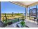 Relaxing screened lanai with wicker furniture overlooking beautiful natural landscape at 10519 Spring Tide Way, Parrish, FL 34219