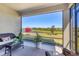 Relaxing screened lanai with wicker furniture overlooking beautiful pond at 10519 Spring Tide Way, Parrish, FL 34219