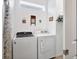 Convenient laundry room featuring washer, dryer and storage shelves at 10519 Spring Tide Way, Parrish, FL 34219