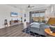 Open-concept living area with wood-look floors, TV, sliding glass doors, and modern furnishings at 10519 Spring Tide Way, Parrish, FL 34219