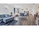 Open-concept living room with hardwood floors connecting the kitchen, dining area and Gathering room at 10519 Spring Tide Way, Parrish, FL 34219