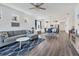 Open-concept living room with hardwood floors connecting the kitchen, dining area and Gathering room at 10519 Spring Tide Way, Parrish, FL 34219