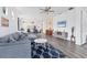 Open-concept living room with hardwood floors connecting the kitchen, dining area and Gathering room at 10519 Spring Tide Way, Parrish, FL 34219