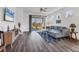 Bright living room features sliding glass doors, recessed lights, ceiling fan and wood-look flooring at 10519 Spring Tide Way, Parrish, FL 34219