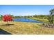 Scenic view of a community pond with lush landscaping at 10519 Spring Tide Way, Parrish, FL 34219