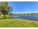View of the tranquil pond in the community with neighborhood homes in the background at 10519 Spring Tide Way, Parrish, FL 34219