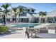 Beautiful pool area with lounge chairs, tables, and lush landscaping for relaxation and recreation at 10519 Spring Tide Way, Parrish, FL 34219