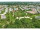 Aerial view of a Primary-planned community with lush landscaping, a pool, and well-maintained homes at 11828 Sky Acres Ter, Bradenton, FL 34211