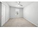 Bright bedroom with neutral carpet, ceiling fan, and a window offering natural light at 11828 Sky Acres Ter, Bradenton, FL 34211