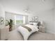 Cozy bedroom with a ceiling fan, neutral decor, and a window offering plenty of natural light at 11828 Sky Acres Ter, Bradenton, FL 34211
