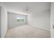 Bright bedroom with neutral carpet, a ceiling fan, and a window offering natural light at 11828 Sky Acres Ter, Bradenton, FL 34211