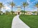 Exterior view of the community clubhouse with vibrant landscaping and palm tree accents at 11828 Sky Acres Ter, Bradenton, FL 34211