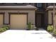 Charming townhouse featuring a one-car garage, stone accents, and well-maintained landscaping at 11828 Sky Acres Ter, Bradenton, FL 34211