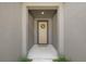 Inviting front entrance featuring a tan door adorned with a wreath and a neutral-colored mat at 11828 Sky Acres Ter, Bradenton, FL 34211