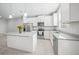Bright and modern kitchen featuring an island, stainless steel appliances, and neutral countertops at 11828 Sky Acres Ter, Bradenton, FL 34211