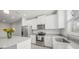 Modern kitchen with white cabinets, stainless appliances, and a center island at 11828 Sky Acres Ter, Bradenton, FL 34211