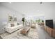 Bright living room with a decorative rug, stylish furniture, and view of kitchen and dining area at 11828 Sky Acres Ter, Bradenton, FL 34211