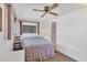Comfortable bedroom with a ceiling fan, natural light and an attached bathroom at 1212 41St Avenue E Dr, Ellenton, FL 34222