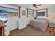 Cozy bedroom features a ceiling fan, and natural light coming through the windows at 1212 41St Avenue E Dr, Ellenton, FL 34222