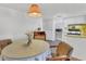 Bright dining area next to the kitchen featuring a glass table and white appliances at 1212 41St Avenue E Dr, Ellenton, FL 34222