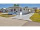 Charming single-story home featuring a screened front porch and covered carport on a sunny day at 1212 41St Avenue E Dr, Ellenton, FL 34222