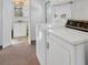 Practical laundry room equipped with washer and dryer, and ample storage space at 1212 41St Avenue E Dr, Ellenton, FL 34222